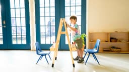 Child painting at easel